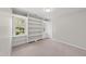 Bright bedroom with built-in shelving, carpeted floors, and natural light at 5317 Peacenest Dr, Raleigh, NC 27610