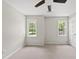 Bedroom featuring neutral walls, carpeted floors, ceiling fan and bright windows at 5317 Peacenest Dr, Raleigh, NC 27610