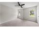 Bedroom with neutral walls, carpeted floors, ceiling fan and bright windows at 5317 Peacenest Dr, Raleigh, NC 27610