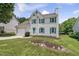 Charming two-story home features a landscaped yard, attached garage, and cheerful turquoise shutters at 5317 Peacenest Dr, Raleigh, NC 27610