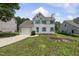 Charming two-story home features a landscaped yard, attached garage, and cheerful turquoise shutters at 5317 Peacenest Dr, Raleigh, NC 27610