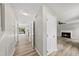 Bright hallway with wood floors leads to living room and kitchen at 5317 Peacenest Dr, Raleigh, NC 27610