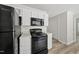 Kitchen with black appliances and white cabinets at 5317 Peacenest Dr, Raleigh, NC 27610