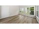 Bright living room featuring hardwood floors and multiple windows providing natural light at 5317 Peacenest Dr, Raleigh, NC 27610