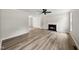 Bright living room features a fireplace, ceiling fan, and beautiful laminate flooring throughout at 5317 Peacenest Dr, Raleigh, NC 27610