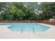 Community pool with no diving signs and a wooded fence for privacy at 5317 Peacenest Dr, Raleigh, NC 27610