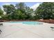 Community pool surrounded by ample seating and a wooded area for privacy at 5317 Peacenest Dr, Raleigh, NC 27610