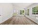 Bright sunroom features cathedral ceilings, many windows, and beautiful laminate flooring throughout at 5317 Peacenest Dr, Raleigh, NC 27610