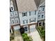 Aerial view of townhouses with brick foundations, gray siding, and driveways at 5505 Heather Garden Way, Raleigh, NC 27613