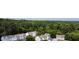 Aerial view of a neighborhood surrounded by lush green trees and a forest backdrop at 5505 Heather Garden Way, Raleigh, NC 27613