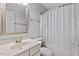 Bathroom featuring a vanity, toilet, mirror, and curtained shower at 5505 Heather Garden Way, Raleigh, NC 27613