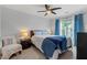 Bright bedroom with a ceiling fan, a dresser, and a comfortable chair in the corner at 5505 Heather Garden Way, Raleigh, NC 27613