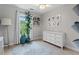 Bright bedroom featuring light gray walls, large window, and decor at 5505 Heather Garden Way, Raleigh, NC 27613