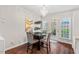 Bright dining area with a chandelier, table with four chairs, and access to the back patio at 5505 Heather Garden Way, Raleigh, NC 27613