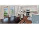 Open concept dining area featuring a table for four, with a view of the kitchen and stainless appliances at 5505 Heather Garden Way, Raleigh, NC 27613