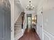 Inviting foyer featuring hardwood floors, a staircase, and a chandelier that offers a warm welcome at 5505 Heather Garden Way, Raleigh, NC 27613
