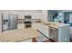This kitchen features stainless steel appliances, granite countertops, white cabinets, and opens to a living area at 5505 Heather Garden Way, Raleigh, NC 27613