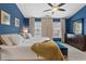 Spacious main bedroom with high ceilings, blue walls, plush carpet, large windows and a ceiling fan at 5505 Heather Garden Way, Raleigh, NC 27613