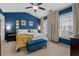 Inviting main bedroom with blue walls, large windows with white curtains, and plush carpeting at 5505 Heather Garden Way, Raleigh, NC 27613