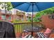 View of the patio with table, chairs, a grill, and umbrella, with lawn in the background at 5505 Heather Garden Way, Raleigh, NC 27613
