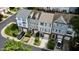 Street view of townhomes featuring attached garages and well-manicured front yards at 5505 Heather Garden Way, Raleigh, NC 27613