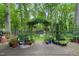 An inviting patio with mature landscaping and views of the lush, wooded backyard at 5523 Newberry Dr, Raleigh, NC 27609