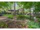Beautiful backyard with a stone border, mature trees, and plenty of space for outdoor activities at 5523 Newberry Dr, Raleigh, NC 27609