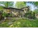 Inviting brick home backyard with patio, mature trees, and lush lawn at 5523 Newberry Dr, Raleigh, NC 27609