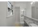 Bright bathroom featuring a tiled shower, granite countertop vanity, and a window providing natural light at 5523 Newberry Dr, Raleigh, NC 27609