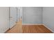 Bedroom featuring hardwood floors, a closet, neutral walls, and multiple doorways at 5523 Newberry Dr, Raleigh, NC 27609