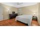 Bedroom with neutral walls, hardwood floors, ceiling fan, and natural light from the window at 5523 Newberry Dr, Raleigh, NC 27609