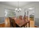 Elegant dining room featuring a chandelier, hardwood floors, and an open layout at 5523 Newberry Dr, Raleigh, NC 27609