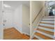 Light-filled entryway with staircase and warm wood floors at 5523 Newberry Dr, Raleigh, NC 27609