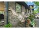 Brick home exterior with a small staircase leading to the yard and mature foliage at 5523 Newberry Dr, Raleigh, NC 27609