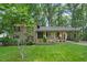 Inviting exterior showcasing a well-manicured lawn, covered parking, and tasteful landscaping at 5523 Newberry Dr, Raleigh, NC 27609