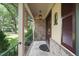Charming front porch with brick accents, elegant railing, and a welcoming entrance at 5523 Newberry Dr, Raleigh, NC 27609