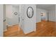 Bright hallway with hardwood floors, neutral walls, and open access to living spaces at 5523 Newberry Dr, Raleigh, NC 27609