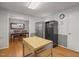Open-concept kitchen with stainless steel appliances and wood floors, leading into the dining room at 5523 Newberry Dr, Raleigh, NC 27609