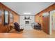 Cozy living room with wood paneling, a brick fireplace, and a comfortable seating area at 5523 Newberry Dr, Raleigh, NC 27609