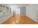 Comfortable living area featuring hardwood floors, large windows, neutral paint, and ample space at 5523 Newberry Dr, Raleigh, NC 27609