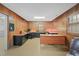 Spacious home office with wood paneling and built-in desks at 5523 Newberry Dr, Raleigh, NC 27609