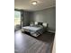 Serene bedroom with natural light, wood floors, modern bed, and stylish gray walls at 57 Winding Ridge Rdg, Sanford, NC 27332