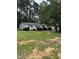 Charming single-story home with blue shutters and a large front yard surrounded by mature trees at 57 Winding Ridge Rdg, Sanford, NC 27332