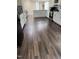 Bright kitchen features ample counter space, clean white cabinetry, and modern luxury vinyl plank flooring at 57 Winding Ridge Rdg, Sanford, NC 27332