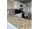 Modern kitchen featuring granite countertops, stainless steel appliances, and white cabinetry at 57 Winding Ridge Rdg, Sanford, NC 27332