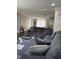 Comfortable living room with wood floors, large couch, and an open connection to other living areas at 57 Winding Ridge Rdg, Sanford, NC 27332