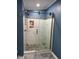 Updated shower with custom tile work, seamless glass door, and modern fixtures at 57 Winding Ridge Rdg, Sanford, NC 27332