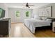 Cozy bedroom with hardwood floors, ceiling fan, and neutral decor at 5809 N Hawthorne Way, Raleigh, NC 27603