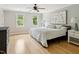 Cozy bedroom with hardwood floors, ceiling fan, and neutral decor at 5809 N Hawthorne Way, Raleigh, NC 27603