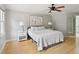 Cozy bedroom with hardwood floors, ceiling fan, and neutral decor at 5809 N Hawthorne Way, Raleigh, NC 27603